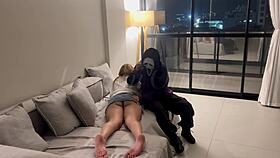 A masked person ties me and holds an object
