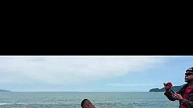redhead wife with blonde friend at empty beach rocks