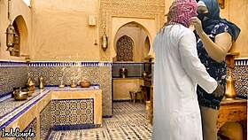 arab husband and asian wife in kitchen
