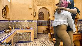 arab husband and asian wife in kitchen