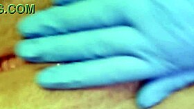 A nurse in gloves masturbates her tight pussy