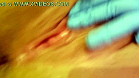 A nurse in gloves masturbates her tight pussy